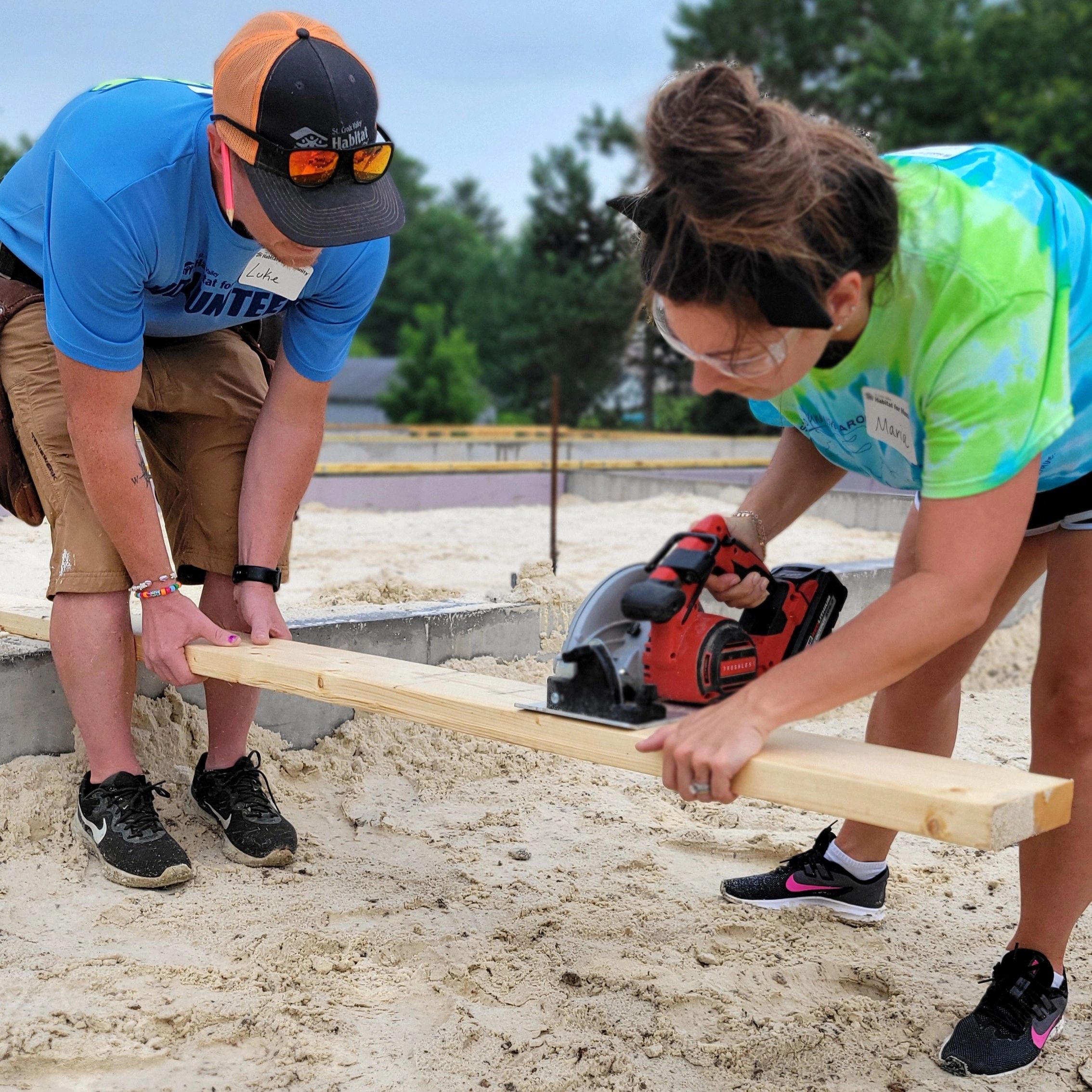 Volunteers working together at a Habitat for Humanity construction site in St. Croix Valley